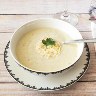 A bowl of cauliflower soup on a table.