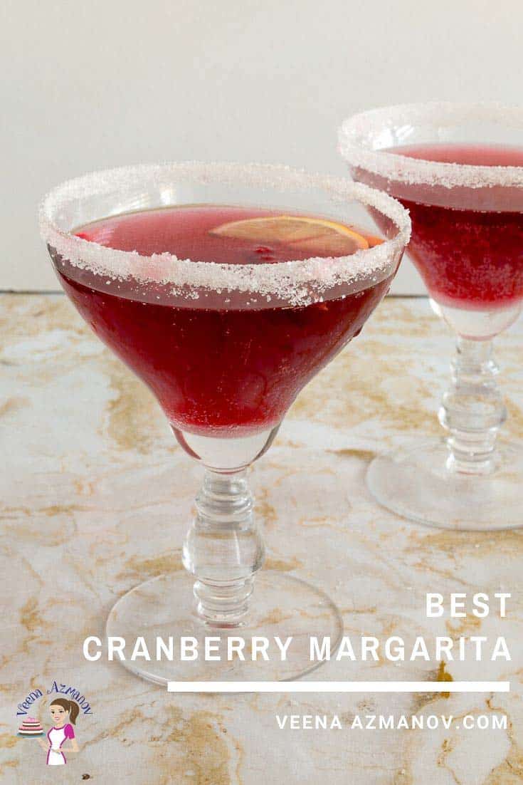 Two glasses of cranberry margarita on a table.