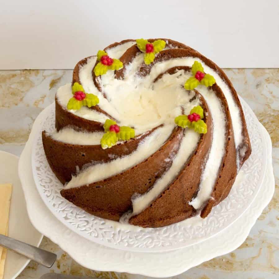 A frosted bundt cake on a cake stand
