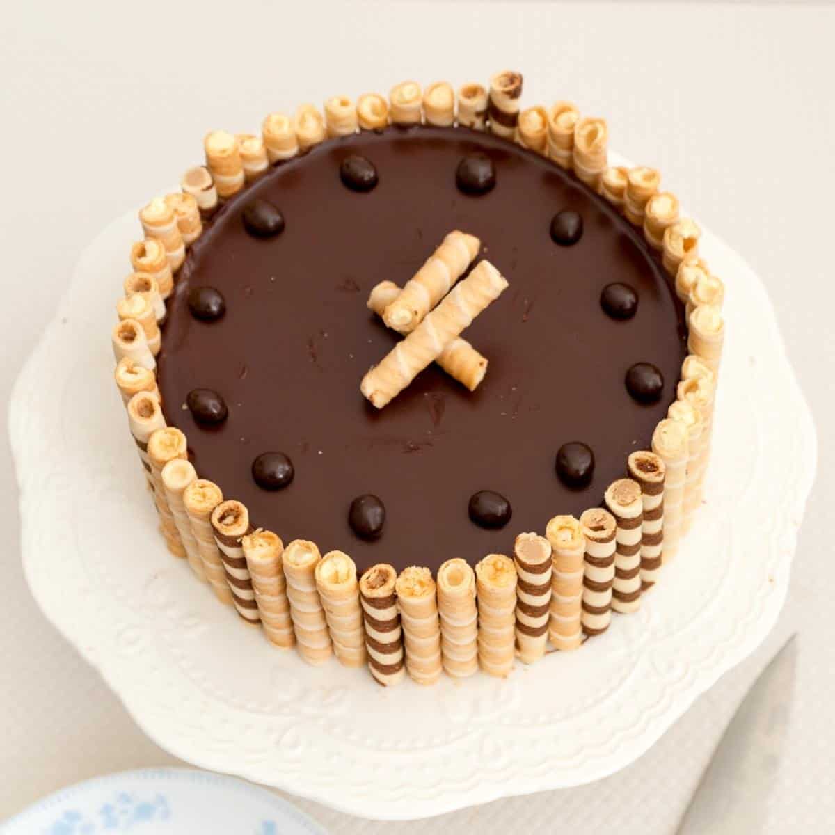 A chocolate cake flourless on a cake stand.