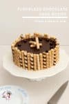 A chocolate cake on a cake stand.
