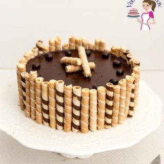 A flourless Chocolate cake on a cake stand.