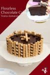 A flourless chocolate cake on a stand.