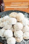 A stack of snowball cookies on a plate.