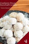 A stack of pecan and cranberries snowball cookies on a plate.