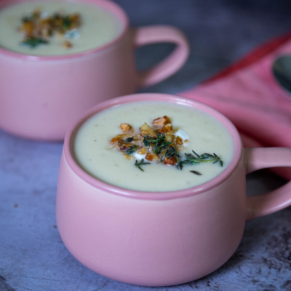 Two mugs of cauliflower soup.