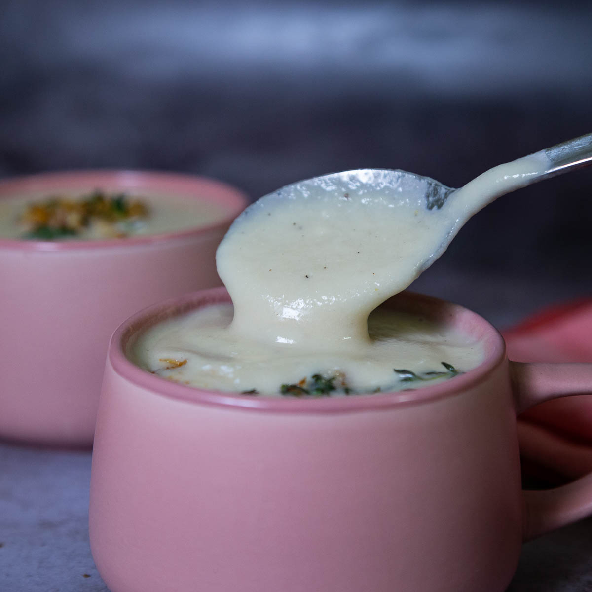 Bowl and spoon with cauliflower soup.