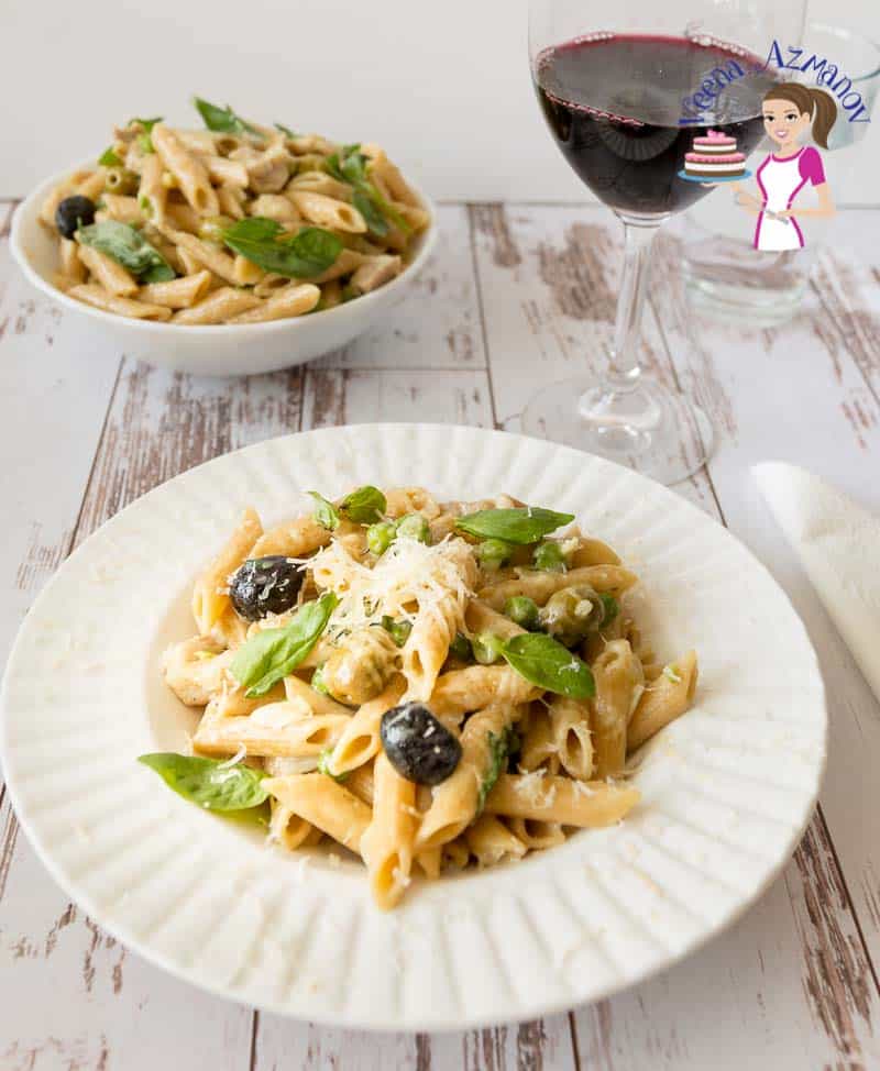 A plate of chicken and penne pasta.