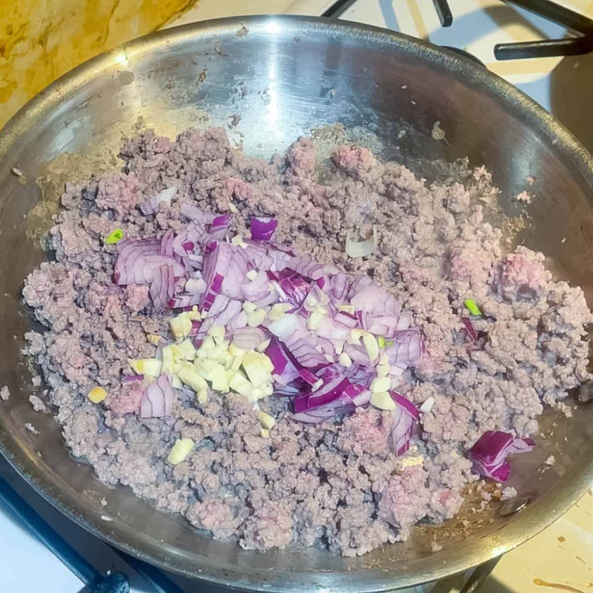Browning the ground beef with onion and garlic.