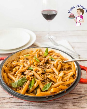 Ground beef with penne pasta in a pan.