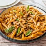 A skillet with ground beef pasta.