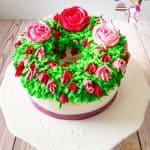 A cake decorated with flowers made with Korean buttercream frosting.