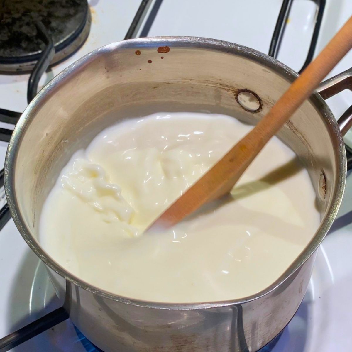 Boiling milk and heavy cream in a saucepan.