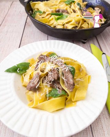 A of pappardelle pasta with lamb on a table.