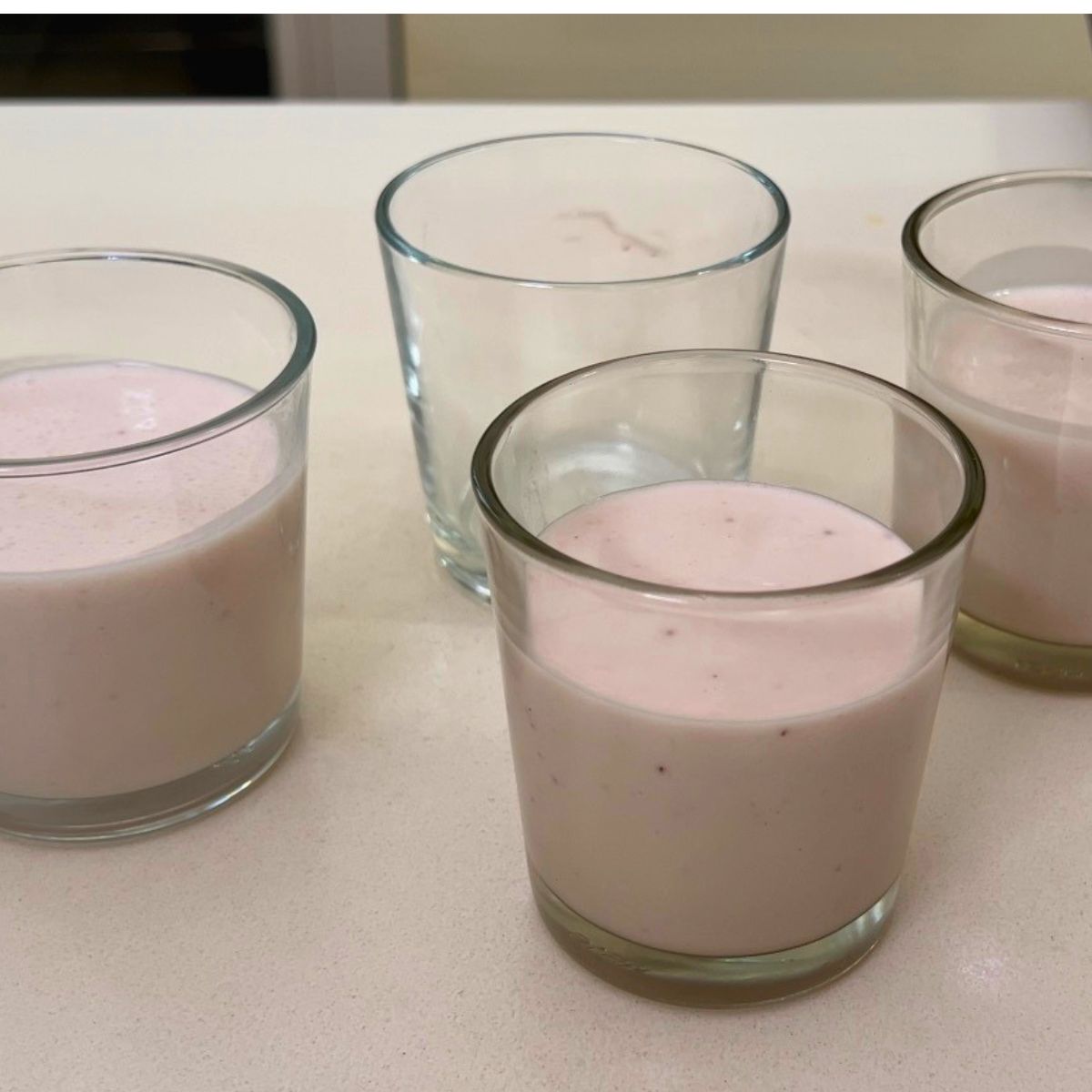 Pouring Panna cotta into a mini cups.