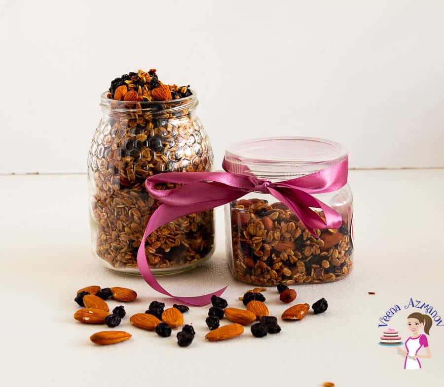 Two jars with homemade granola and blueberries and almonds.