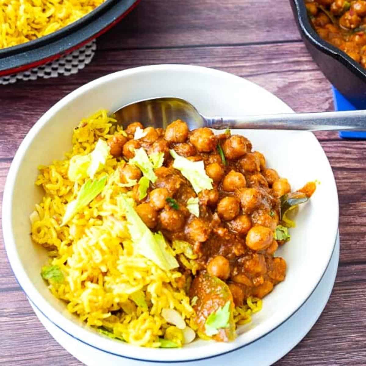 A bowl with turmeric rice and chickpeas curry.