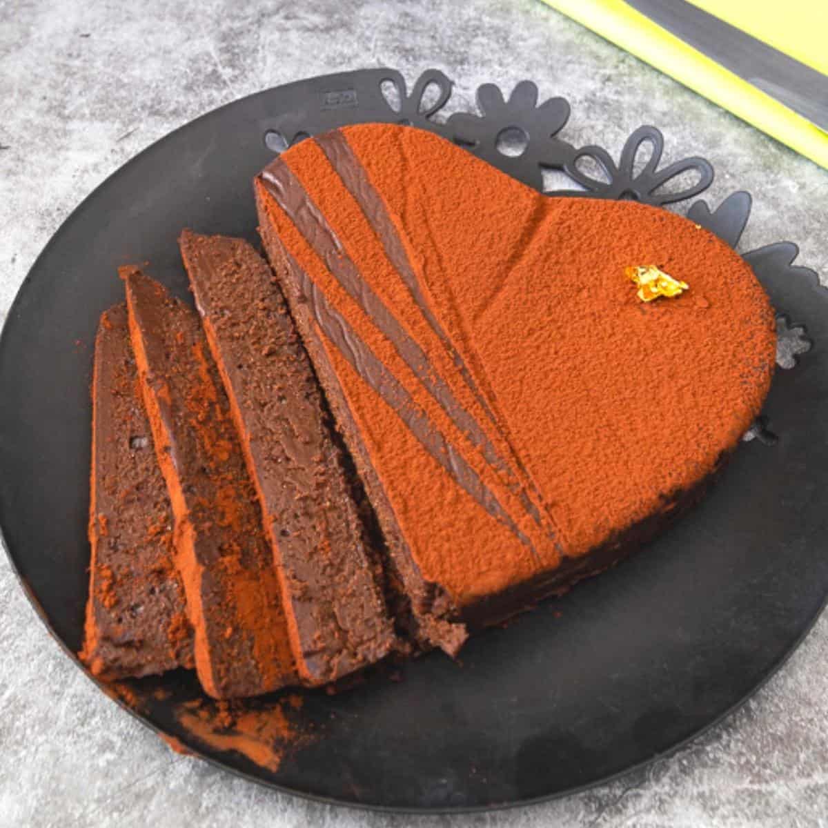 A sliced chocolate terrine on a black plate.