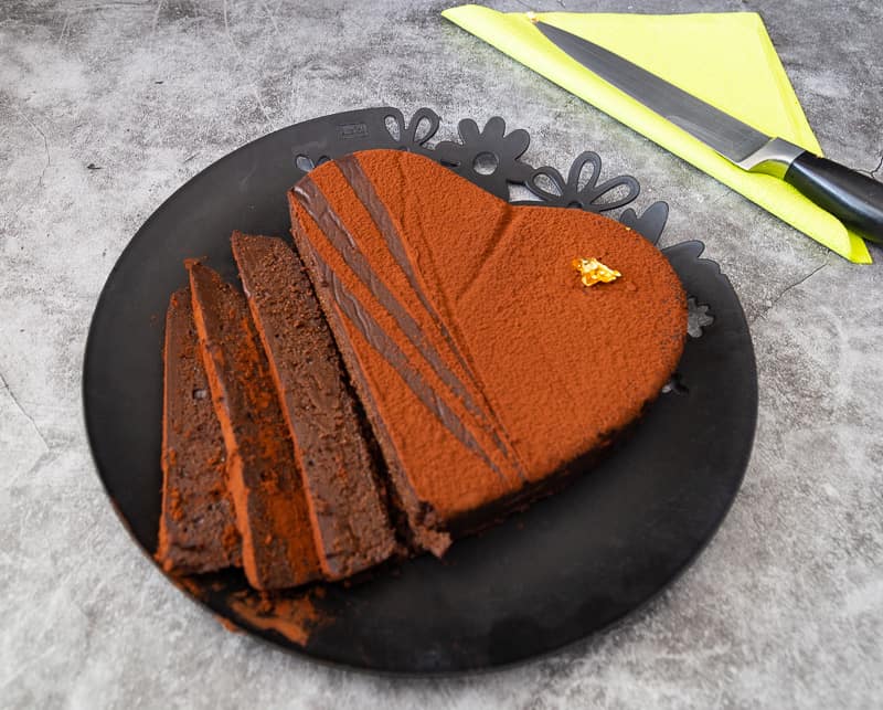 A heart-shaped chocolate terrine dessert sliced.