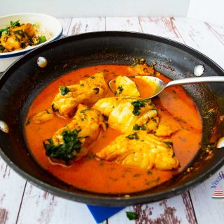 A skillet with fish curry.