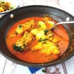 A skillet with curry - fish.