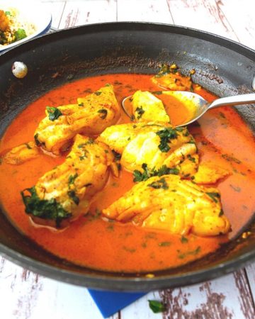 A skillet with curry - fish.