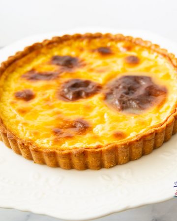 A French custard tart on a cake stand.