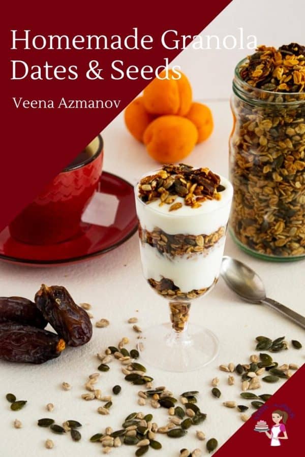 Granola in a jar next to a glass with yogurt parfait, and a cup of tea.