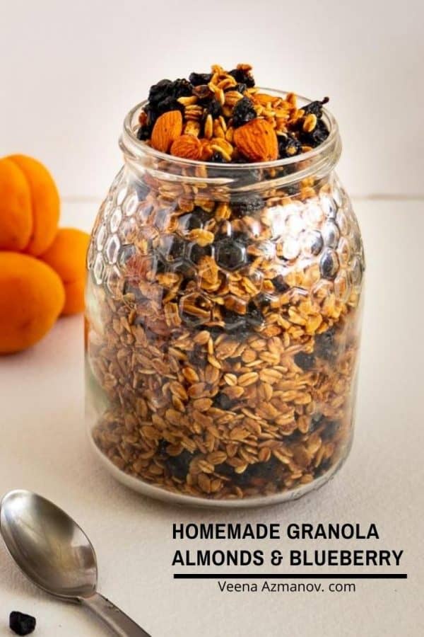 A jar with homemade granola and blueberries.