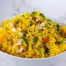 A bowl with coconut and turmeric rice.
