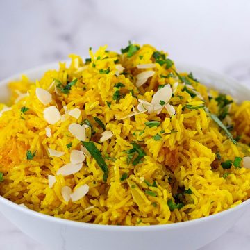 A white bowl with turmeric yellow rice.