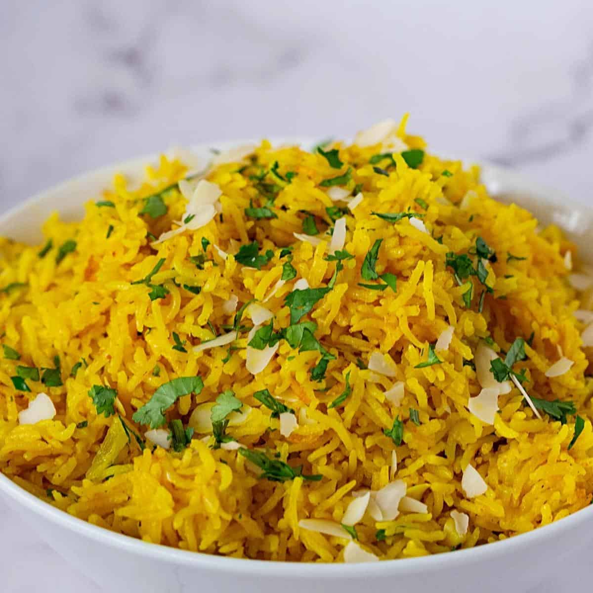 A bowl with flavored yellow rice with coconut milk.