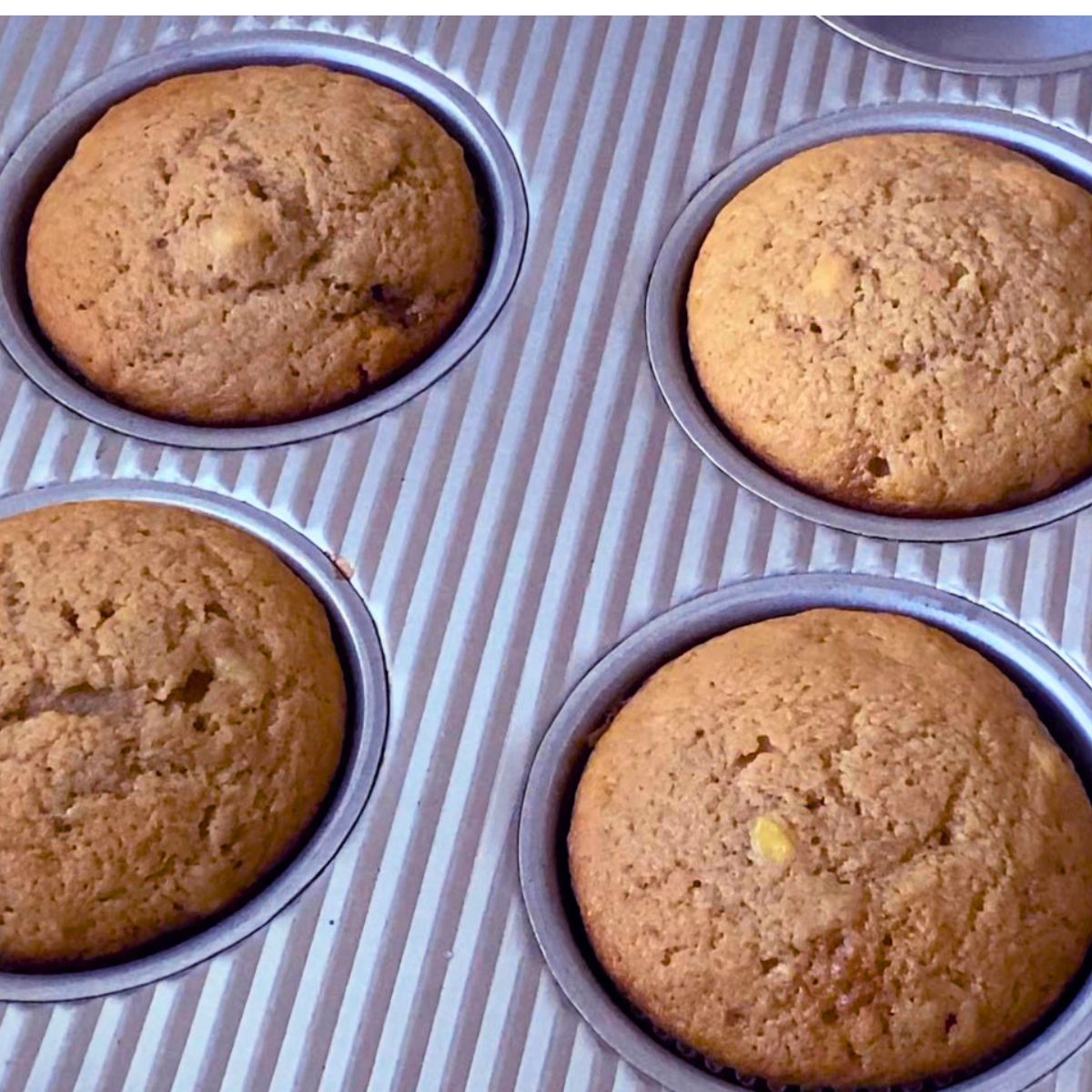 Muffin pan with banana cupcake batter for baking.
