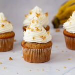 Cream Cheese frosted Moist Banana Cupcakes on the table.
