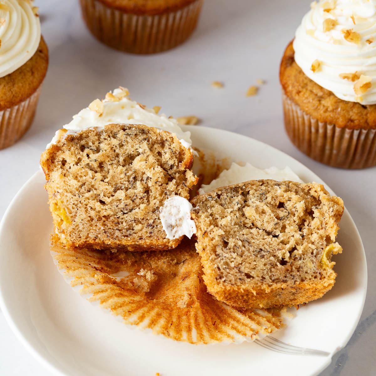 A saucer with banana cupcakes cut in half.