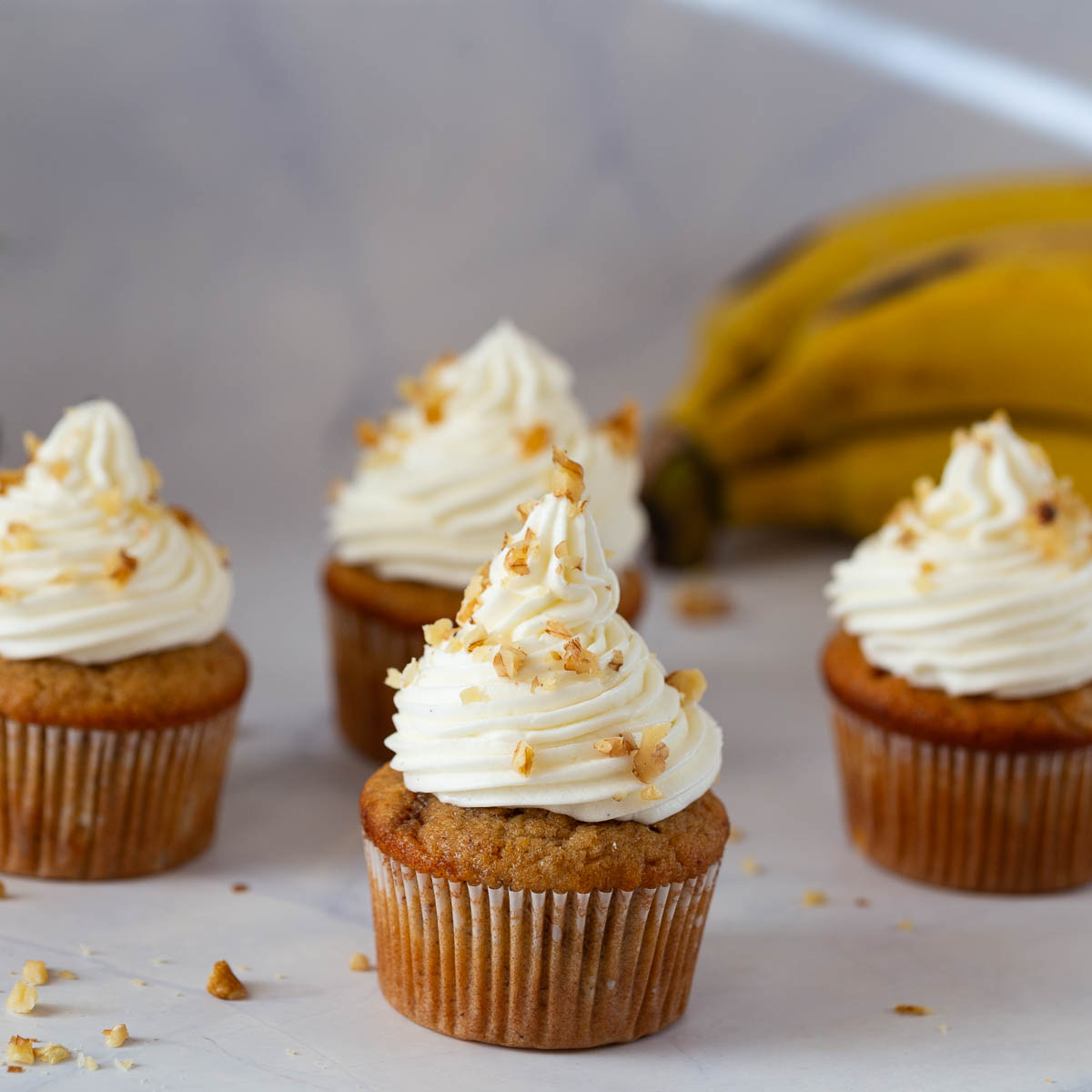 Frosted Banana cupcakes on the table.