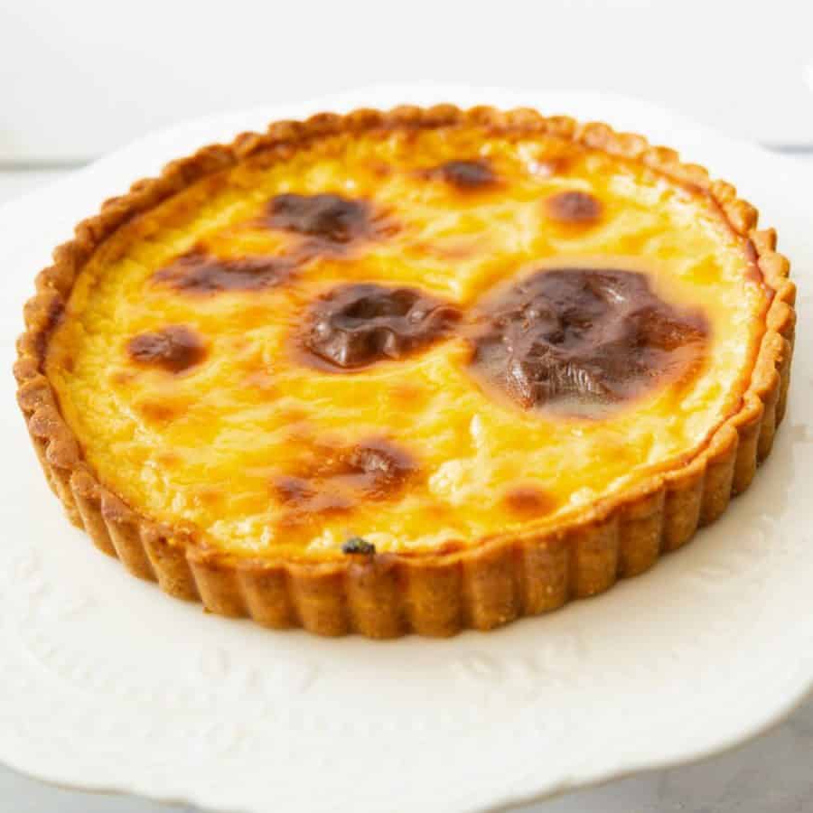 A Parisian flan tart on the cake stand.