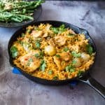 A skillet with chicken and rice.