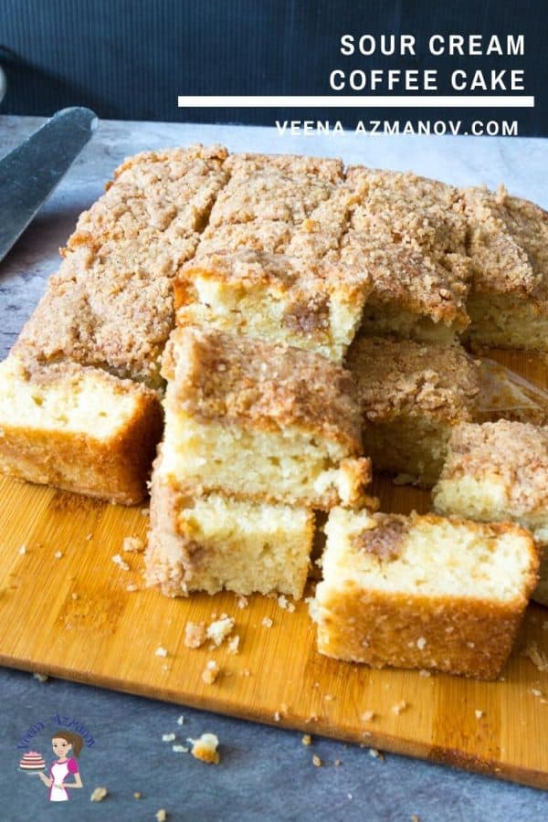 A stack of coffee cake squares on a wooden board.