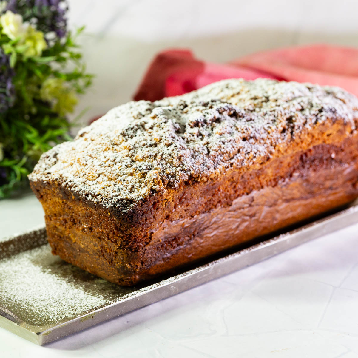 A sour cream loaf cake dusted with powdered sugar.
