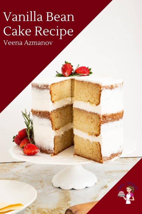A sliced vanilla bean cake on a cake stand.