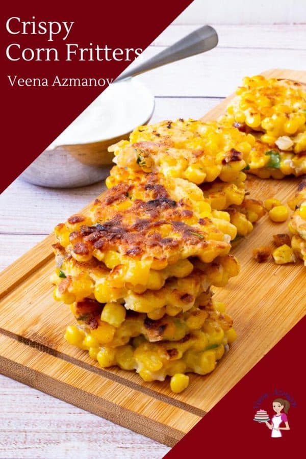 A stack of corn fritters on a wooden board.