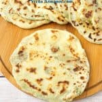 A wooden board with mashed potato flatbread,