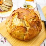 A loaf of bread on a wooden cutting board