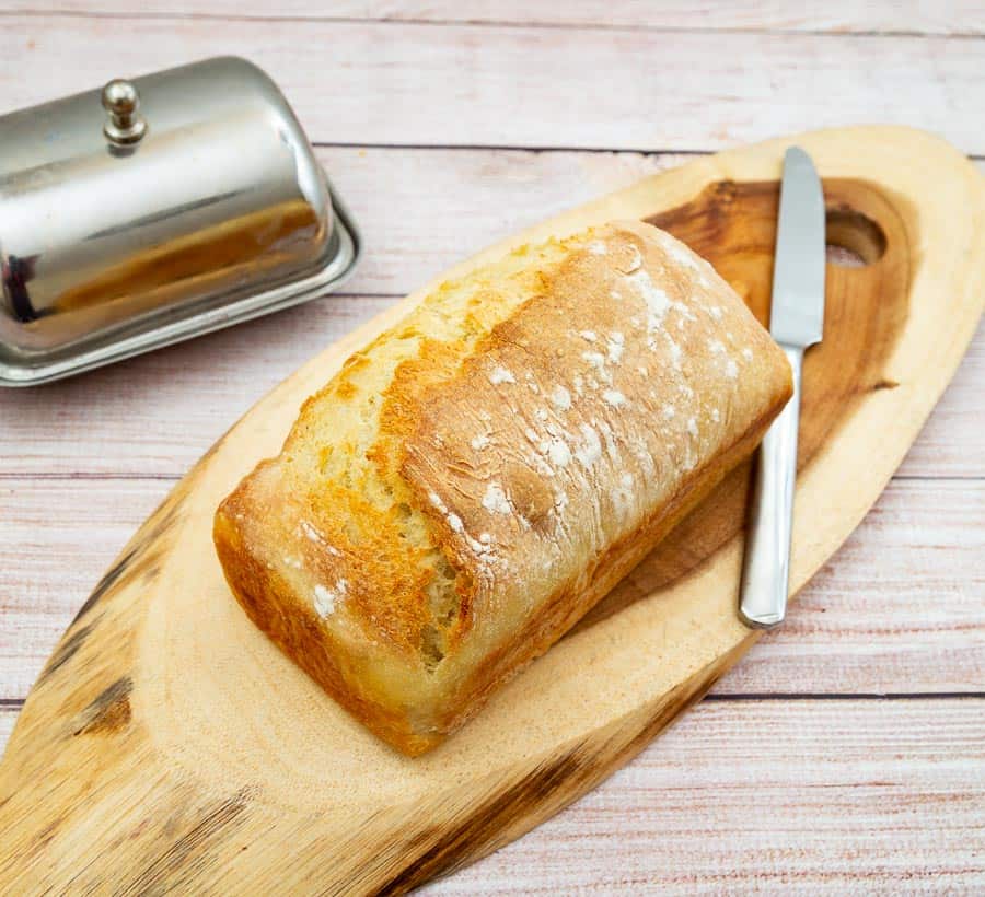 A sandwich bread on a wooden board.