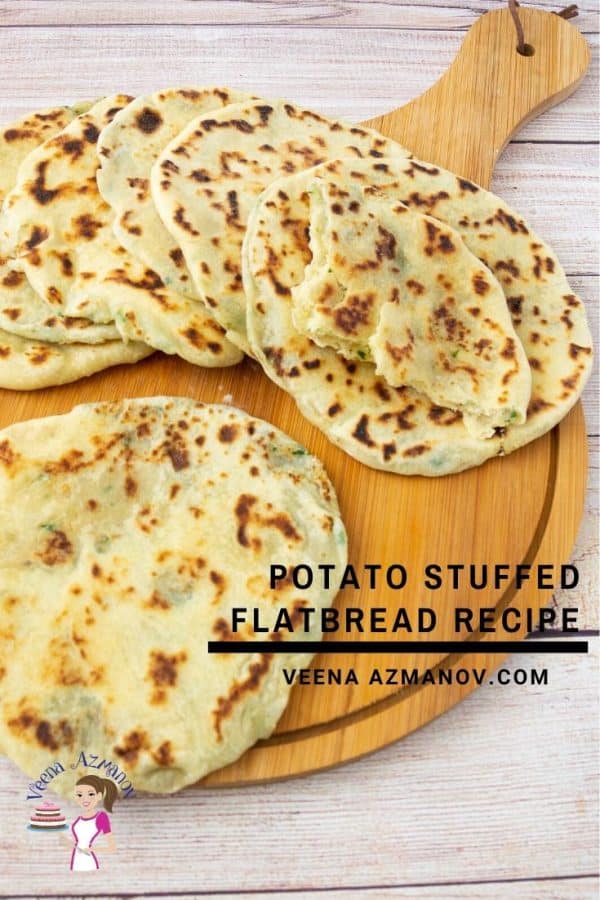 Potato flatbread stacked on a wooden tray.