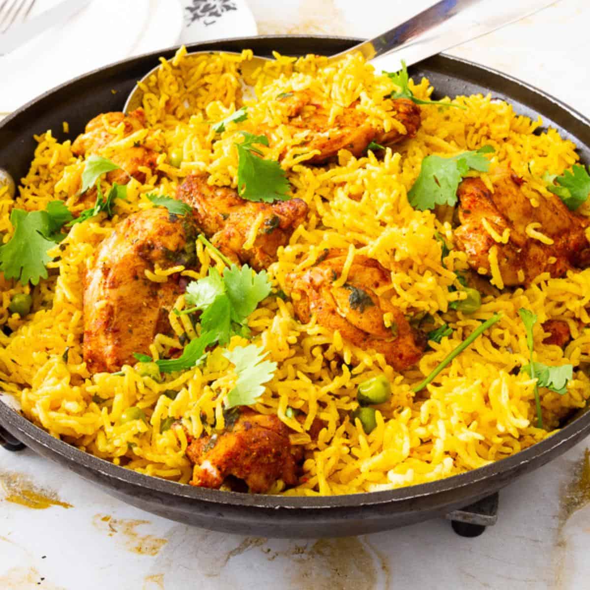 A skillet with chicken and rice.