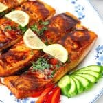 A platter with pan fried salmon.