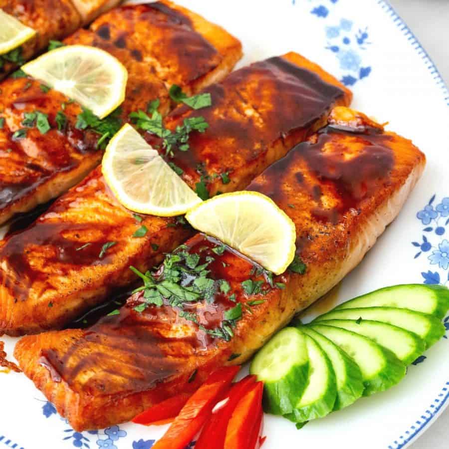 A platter with pan fried salmon.