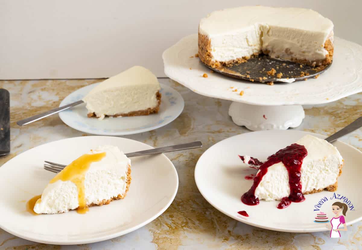 Three slices of cheesecake on three plates.